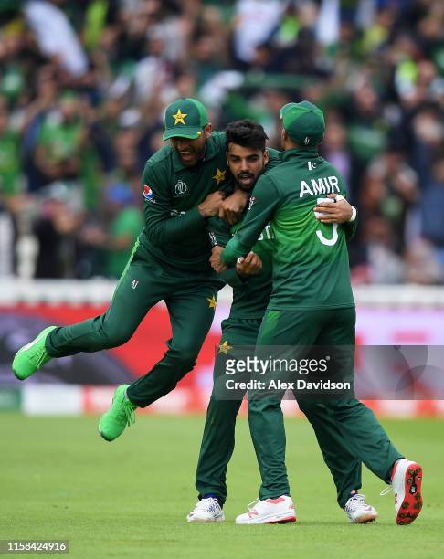 Shadab Khan of Pakistan celebrates after taking the wicket of Kane Williamson with Fakhar Zaman and Mohammad Amir of Pakistan during the Group Stage...