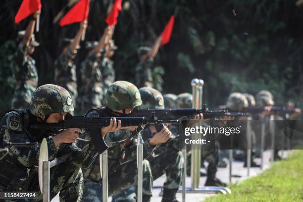 This photo taken on July 29, 2019 shows Chinese paramilitary police officers taking part in a skill competition in Xiangxi in China's central Hunan...