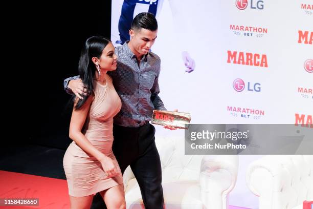 Cristiano Ronaldo and Georgina Rodriguez posing to media with 'Marca Leyenda' award on July 29, 2019 in Madrid, Spain. The award is attributed to...