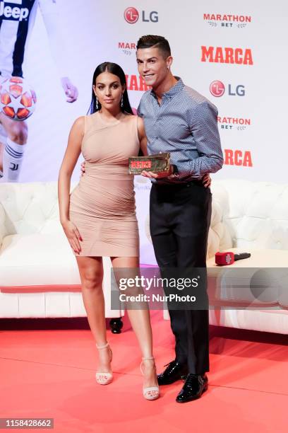 Cristiano Ronaldo and Georgina Rodriguez posing to media with 'Marca Leyenda' award on July 29, 2019 in Madrid, Spain. The award is attributed to...