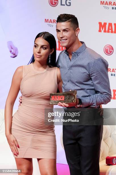 Cristiano Ronaldo and Georgina Rodriguez posing to media with 'Marca Leyenda' award on July 29, 2019 in Madrid, Spain. The award is attributed to...