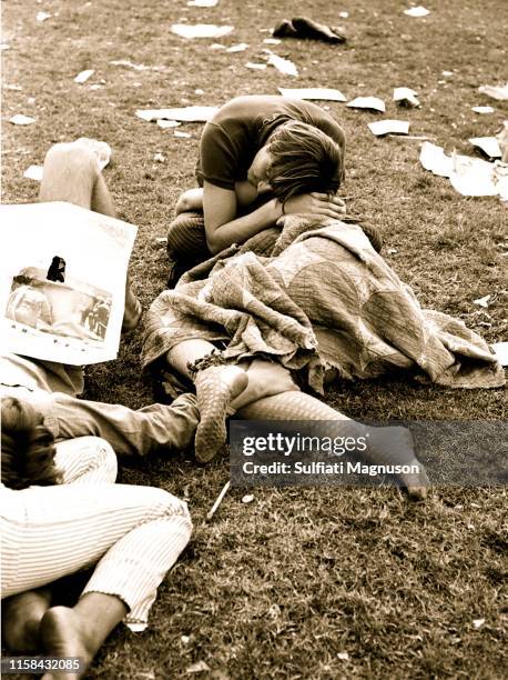 Two intertwined couples napping on the grass with a quilt covering a woman in fishnet stockings at the 1st Elysian Park Love-In on March 26, 1967 in...