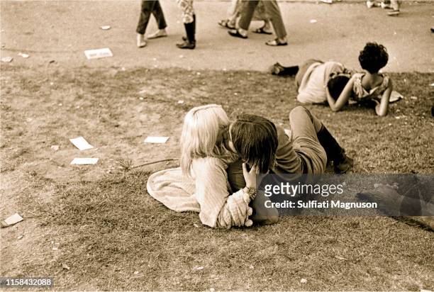 One couple kissing on the grass, another comfortable intertwined at the 1st Elysian Park Love-In on March 26, 1967 in Los Angeles, California.