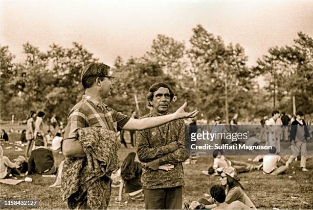 Young "engineer type" man asking a Native American man, "What's going on here?" at the 1st Elysian Park Love-In on March 26, 1967 in Los Angeles,...