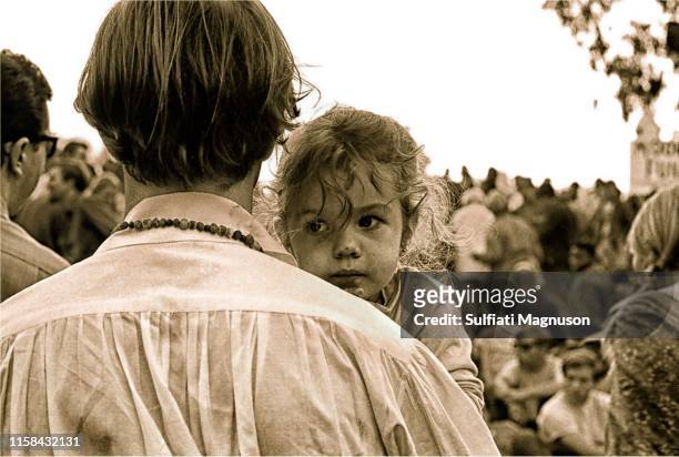 Father's back as he hold his young daughter at the 1st Elysian Park Love-In on March 26, 1967 in Los Angeles, California.