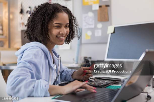 teen girl refers to internet for repair instructions - computer repair stock pictures, royalty-free photos & images