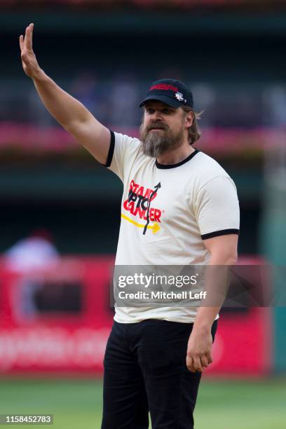 Actor David Harbour throws out the first ball prior to the game between the New York Mets and Philadelphia Phillies at Citizens Bank Park on June 25,...