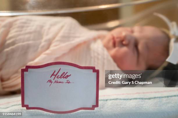 newborn baby girl with tag my name is - name stock pictures, royalty-free photos & images