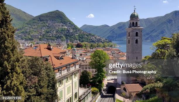 view from above of the historic center of lugano and of the lake of lugano, on the border between southern switzerland and northern italy - lugano stock-fotos und bilder