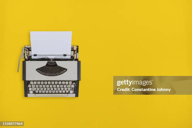 typewriter on yellow background - タイプライター ストックフォトと画像