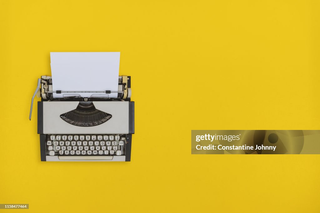 Typewriter on Yellow Background