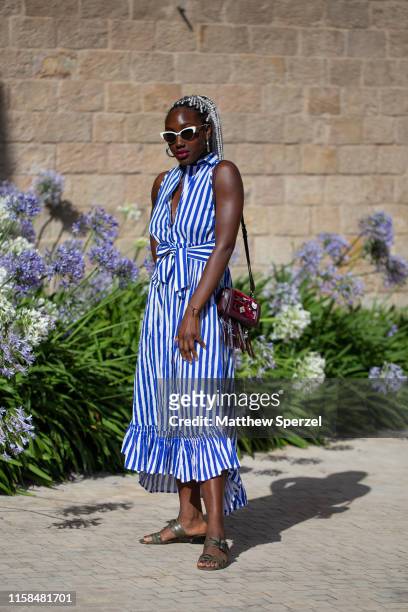 Guest is seen on the street attending 080 Barcelona Fashion Week wearing blue/white striped dress on June 26, 2019 in Barcelona, Spain.