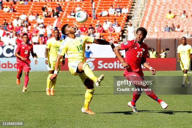 Emery Welshman of Guyana attempts to keep control of the ball from Michael Murillo of Panama during the CONCACAF Gold Cup Group D match at...