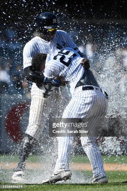 Didi Gregorius of the New York Yankees hugs Gleyber Torres after Torres' walk-off single during the ninth inning of the game against the Toronto Blue...