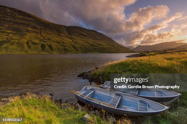 a highland loch. - rowing boat stock pictures, royalty-free photos & images