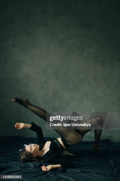 young woman making stretch exercises - women in nylons bildbanksfoton och bilder