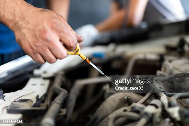 check the oil in car engine - car lubricants stock pictures, royalty-free photos & images