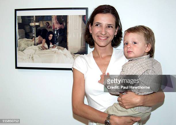 Princess Alexandra of Greece with her son Darius stand next to a photo of Princess Alexandra's mother