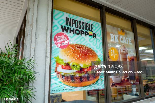 Sign on facade advertising Impossible Whopper, a meat-free item using engineered, plant-protein based burger patty from food technology company...