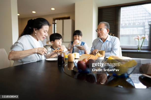 taiwanese family enjoying breakfast together - sandwich generation stock pictures, royalty-free photos & images