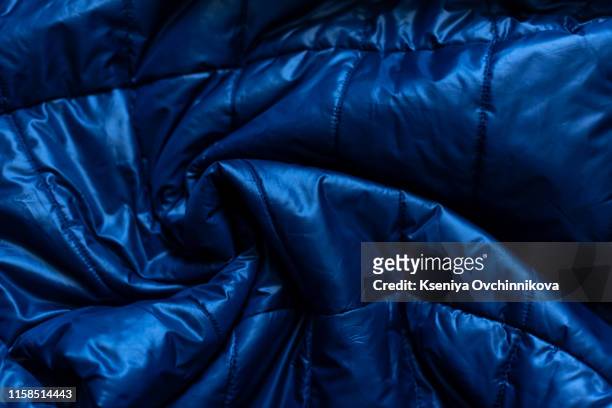 down jacket fabric background, blue puffer jacket texture - nylon imagens e fotografias de stock