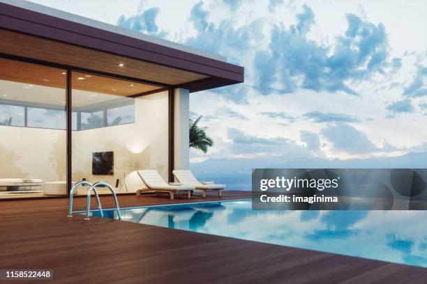 casa de lujo moderna con piscina infinita al amanecer - garden decking fotografías e imágenes de stock