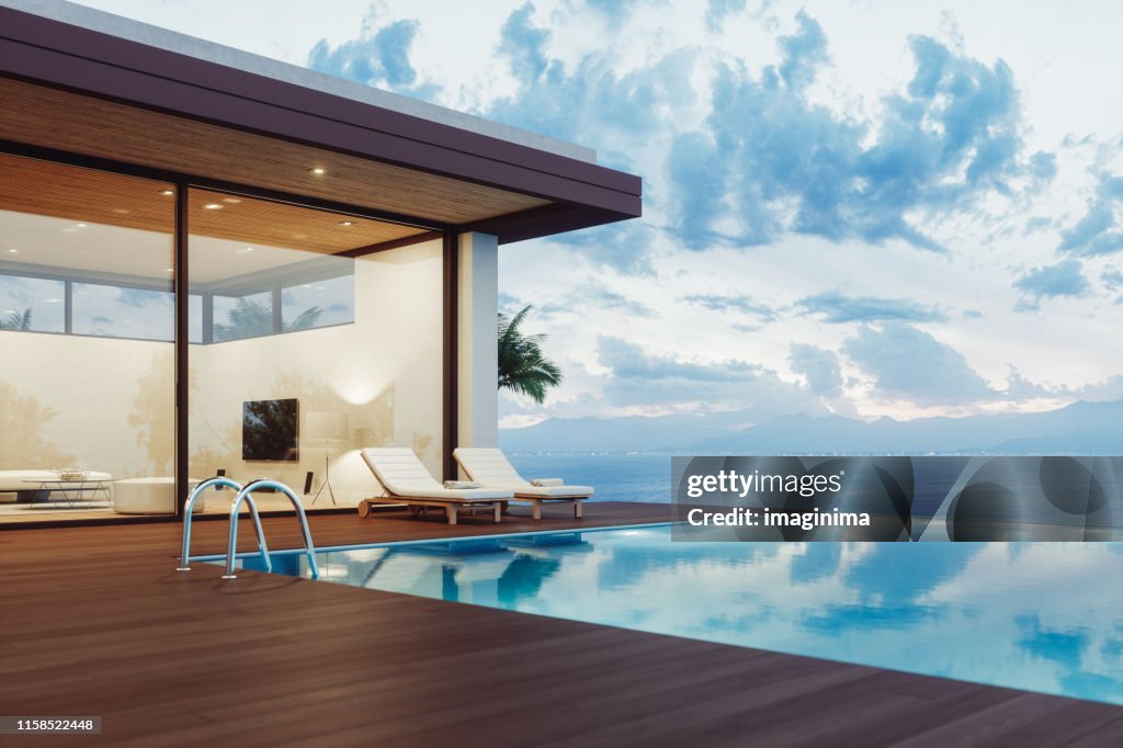 Modern Luxury House With Infinity Pool At Dawn