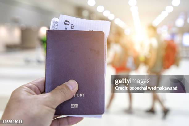 passport and boarding pass looks at the airport departure - canadian passport stock-fotos und bilder