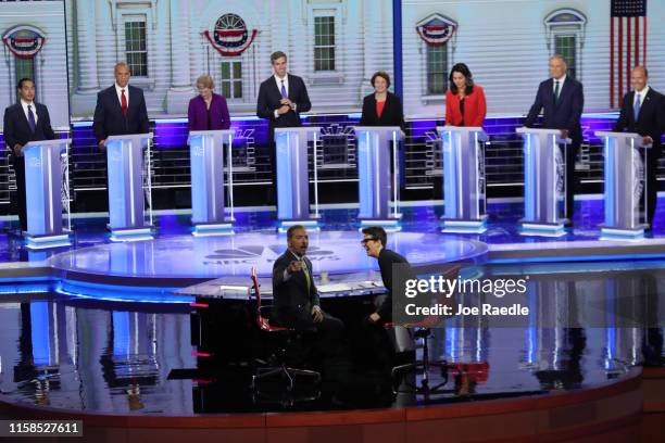 Chuck Todd of NBC News and Rachel Maddow of MSNBC and candidates react to technical difficulties during the first night of the Democratic...