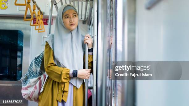 young woman on the train - indonesian ethnicity stock pictures, royalty-free photos & images