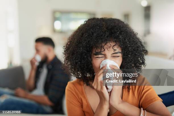 who invited these flu germs to the party? - sick woman blowing nose stock pictures, royalty-free photos & images