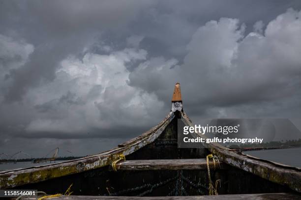 fishing boat and the sky - kerala rain stock-fotos und bilder