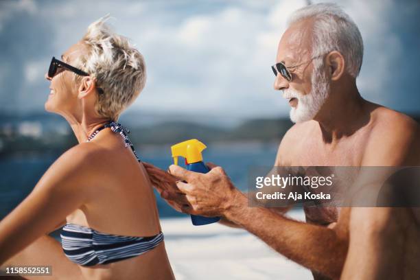 wear sunscreen and protect your skin. - couple on cruise ship stock pictures, royalty-free photos & images