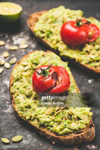 mashed avocado and roasted tomato on bread - avacado oil stock pictures, royalty-free photos & images