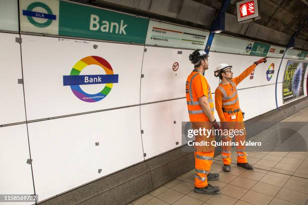 Workers stands by a TFL Pride roundel at Bank Station on June 26, 2019 in London, United Kingdom. The first Gay Pride Rally was held in London on 1...