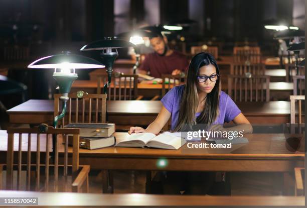 femme d'asie de l'est affichant dans la bibliothèque - science photo library photos et images de collection