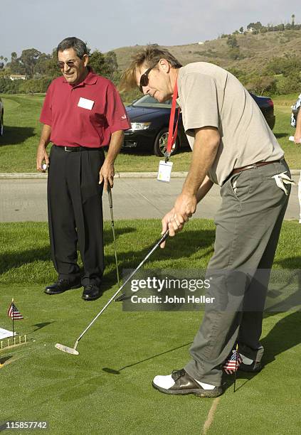 Brett Cullen putts on the first hole of the putting contest