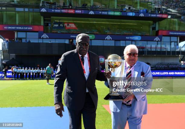 Former West Indies Cricketer Clive Lloyd and Former India Cricketer Farokh Engineer carry out the trophy prior to the national anthems during the...