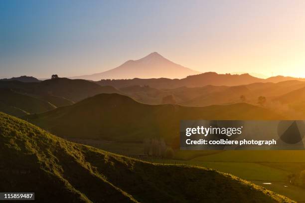 mount egmont with hilly countryside - mt taranaki stock pictures, royalty-free photos & images