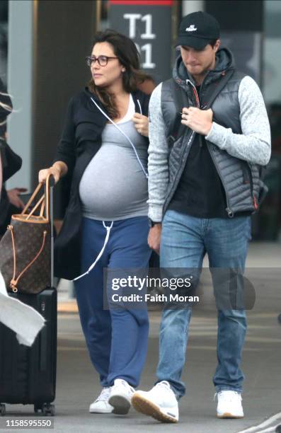 Robbie Amell and his pregnant wife Italia Ricci are seen arriving at Perth Airport on June 27, 2019 in Perth, Australia.