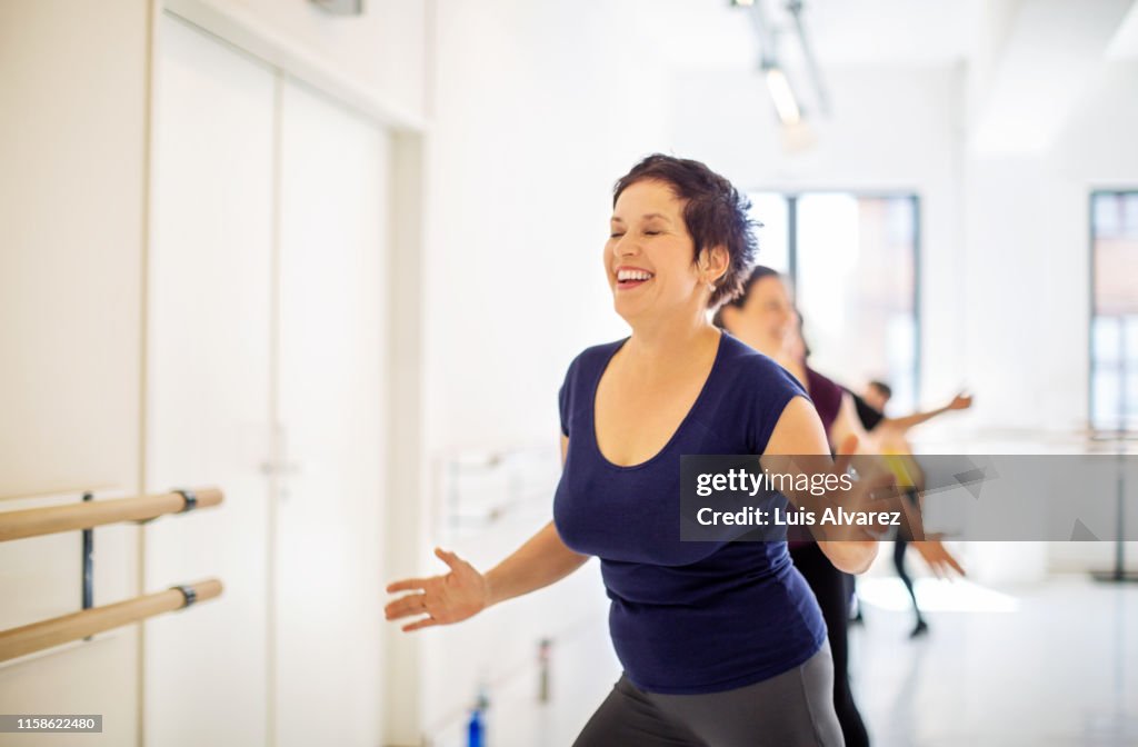 Mature woman enjoying dance in fitness studio