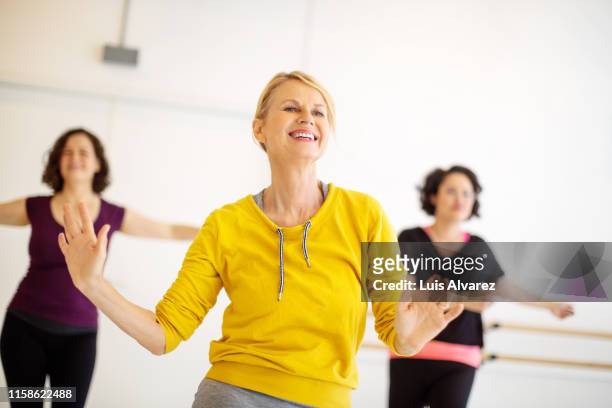 group of women dancing in fitness studio - gym friends stock-fotos und bilder