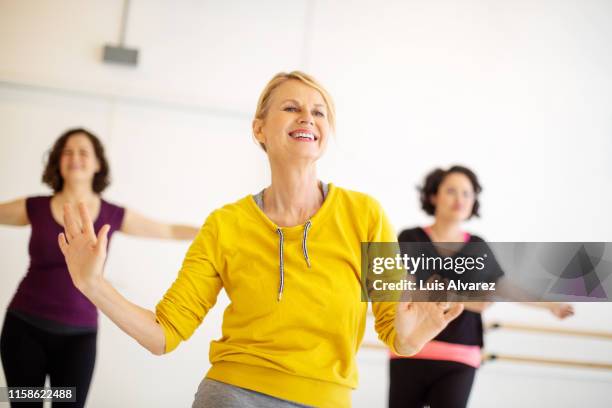 group of women dancing in fitness studio - zumba fitness stockfoto's en -beelden