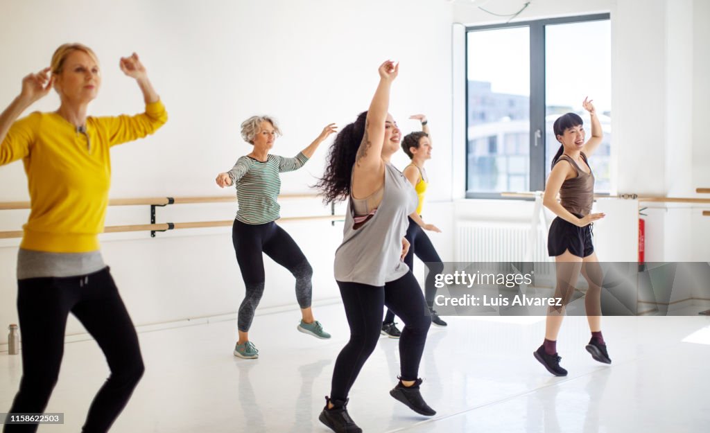 Group of women learning fitness dance in class