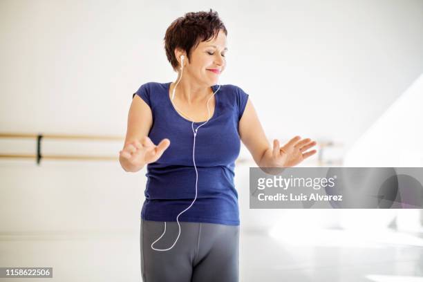 Woman practicing fitness dance with music