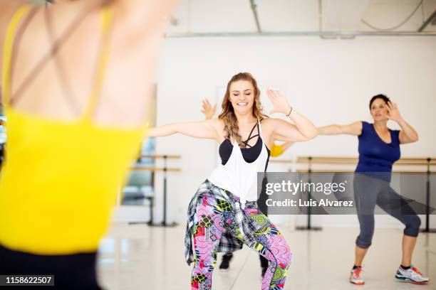 group of women dancing at health studio - zumba stockfoto's en -beelden