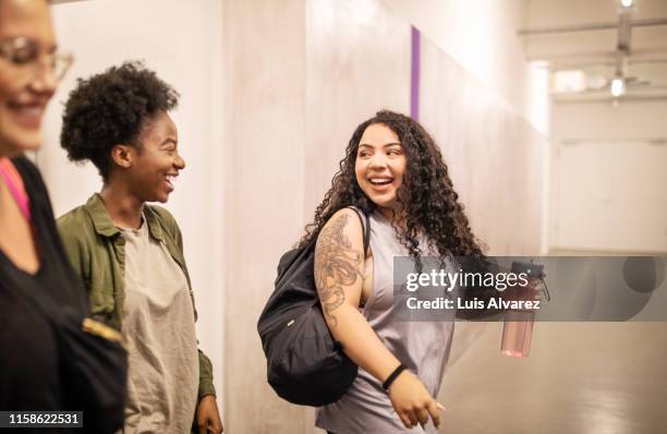 smiling females entering dance studio - short hair for fat women stock pictures, royalty-free photos & images