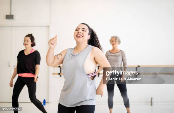 woman enjoying dancing at health center - fat woman dancing stockfoto's en -beelden