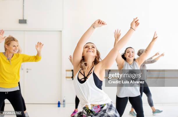 multi-ethnic women are dancing together at health club - fat woman dancing stock pictures, royalty-free photos & images