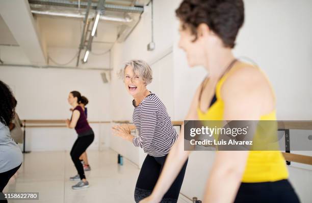 women enjoying a dance routine in fitness studio - gym friends stock-fotos und bilder